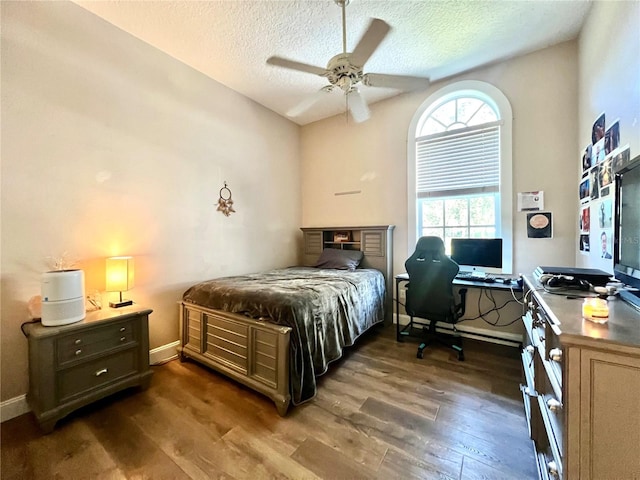 bedroom featuring a textured ceiling, dark hardwood / wood-style flooring, and ceiling fan