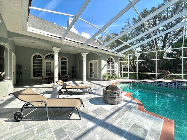 view of pool featuring a lanai, french doors, a patio, and a fire pit