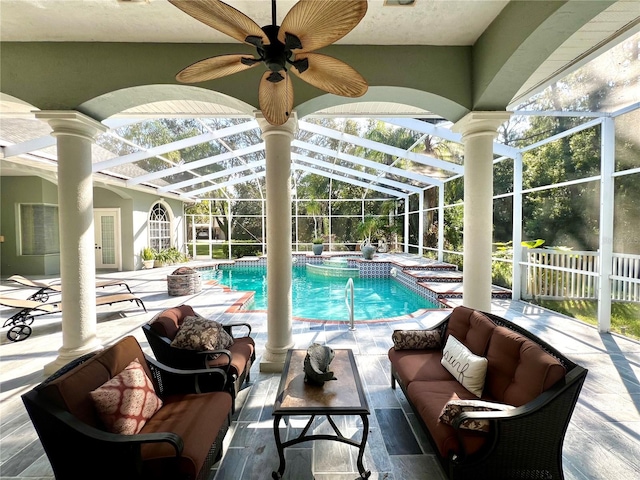 view of swimming pool with outdoor lounge area, ceiling fan, glass enclosure, an in ground hot tub, and a patio