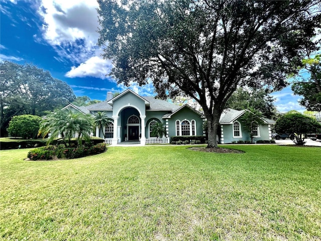 ranch-style house featuring a front lawn and a porch