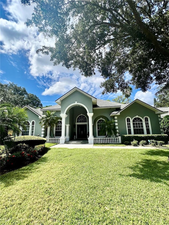 view of front of home with a front yard and a porch