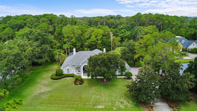 168 Rue Des Chateaux, Tarpon Springs, FL 34688 - aerial view of property and surrounding area featuring a heavily wooded area