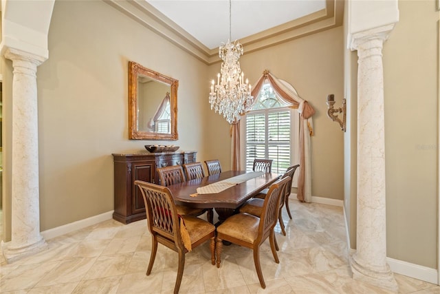 168 Rue Des Chateaux, Tarpon Springs, FL 34688 - dining room with ornate columns, a chandelier, and a tray ceiling