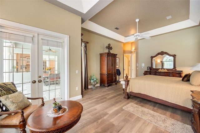 168 Rue Des Chateaux, Tarpon Springs, FL 34688 - bedroom with access to exterior, a raised ceiling, light wood finished floors, french doors, and a ceiling fan