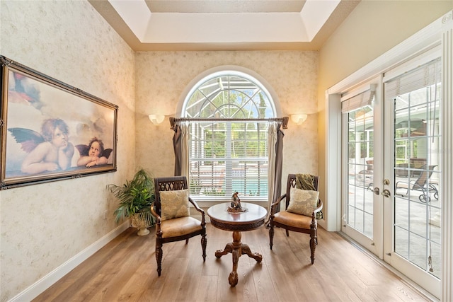 168 Rue Des Chateaux, Tarpon Springs, FL 34688 - sitting room featuring wood finished floors, a tray ceiling, and french doors