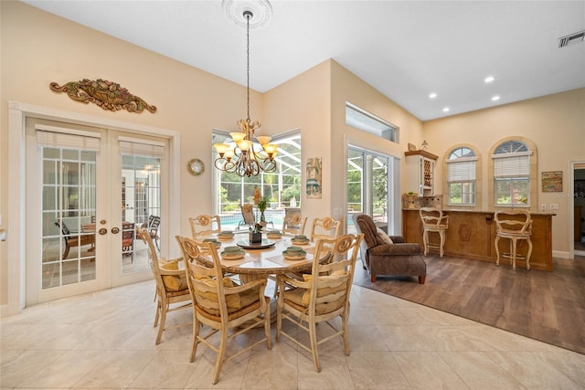 168 Rue Des Chateaux, Tarpon Springs, FL 34688 - dining room with french doors, plenty of natural light, recessed lighting, a chandelier, and light tile patterned floors