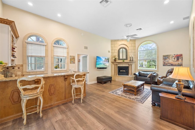 168 Rue Des Chateaux, Tarpon Springs, FL 34688 - living area featuring wood finished floors, ceiling fan, a fireplace with raised hearth, and recessed lighting