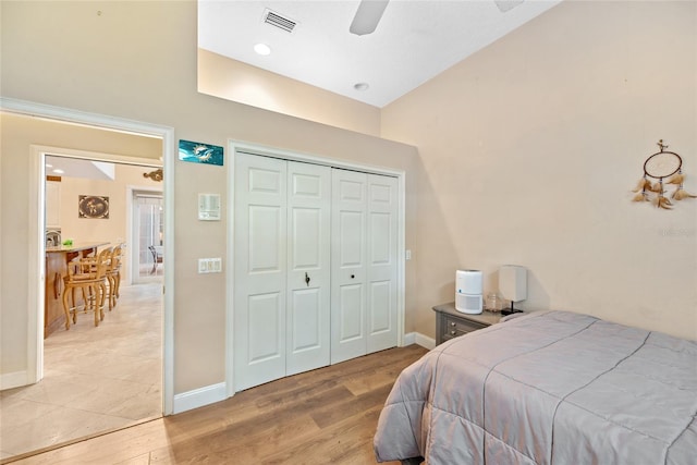168 Rue Des Chateaux, Tarpon Springs, FL 34688 - bedroom featuring light wood-style flooring, a closet, a ceiling fan, and a high ceiling