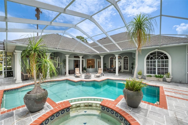 168 Rue Des Chateaux, Tarpon Springs, FL 34688 - view of swimming pool with a patio, glass enclosure, and a pool with connected hot tub
