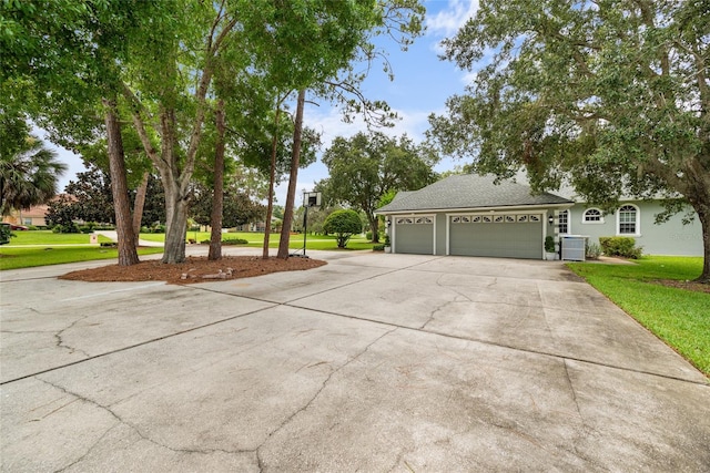 168 Rue Des Chateaux, Tarpon Springs, FL 34688 - view of front of home featuring concrete driveway, a front yard, and a garage
