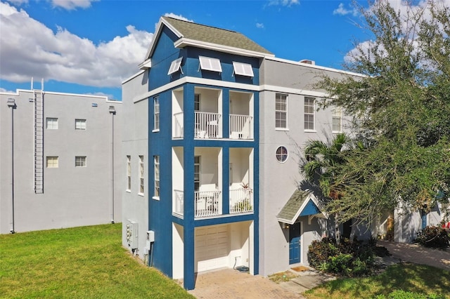 exterior space with a yard and a balcony