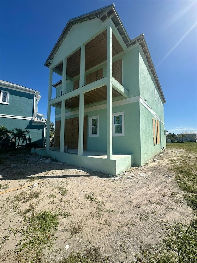 back of property with a patio area and a balcony