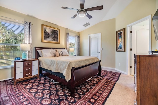 carpeted bedroom with ceiling fan and vaulted ceiling