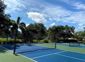 view of sport court with basketball hoop