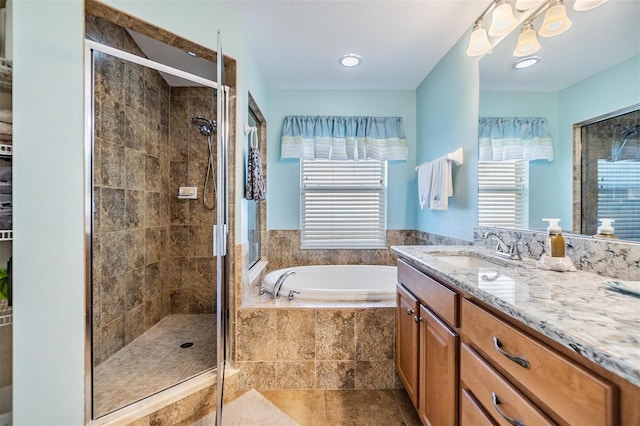 bathroom featuring vanity and shower with separate bathtub