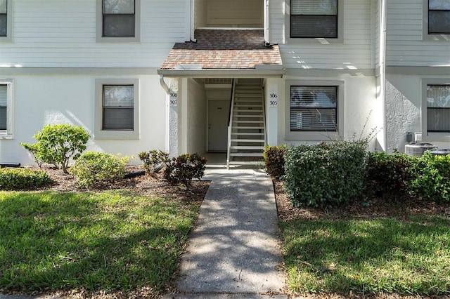 doorway to property featuring a yard