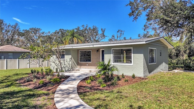 ranch-style home with a front lawn