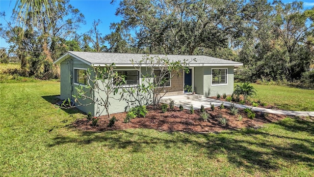 ranch-style home featuring a front yard