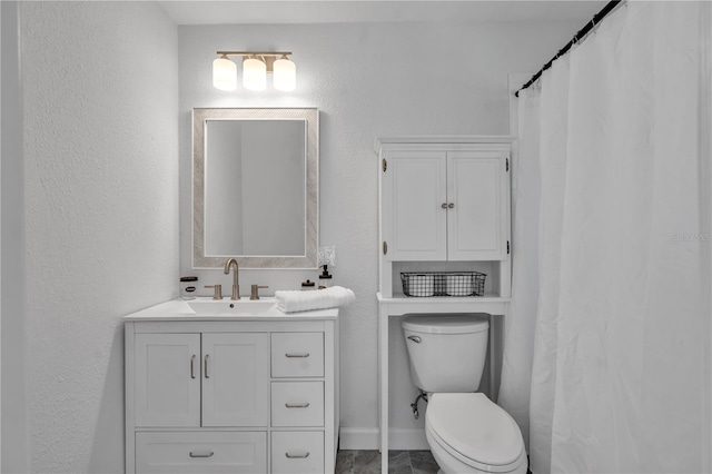 bathroom featuring vanity and toilet