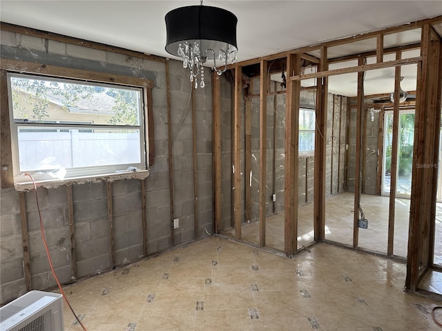 miscellaneous room featuring an inviting chandelier