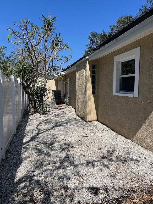 view of property exterior featuring central AC and a patio