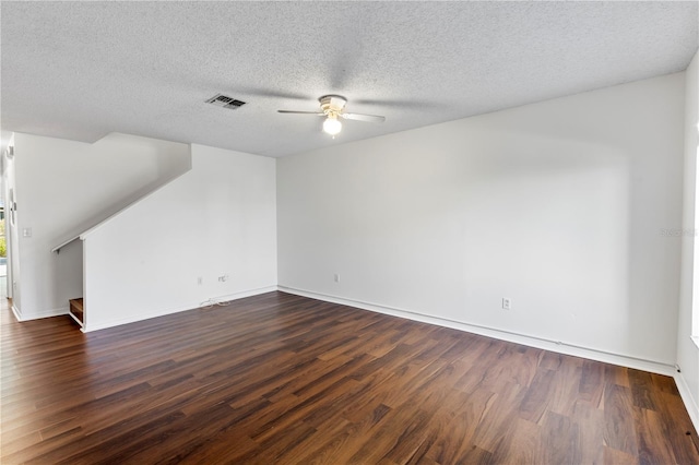 unfurnished living room with dark wood-type flooring, ceiling fan, and a textured ceiling