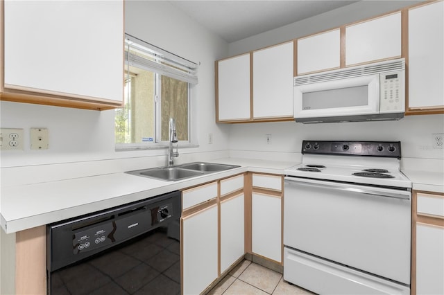 kitchen featuring sink, white cabinets, white appliances, and light tile patterned floors