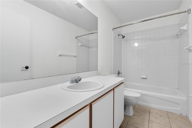 full bathroom featuring vanity, tiled shower / bath combo, toilet, and tile patterned flooring