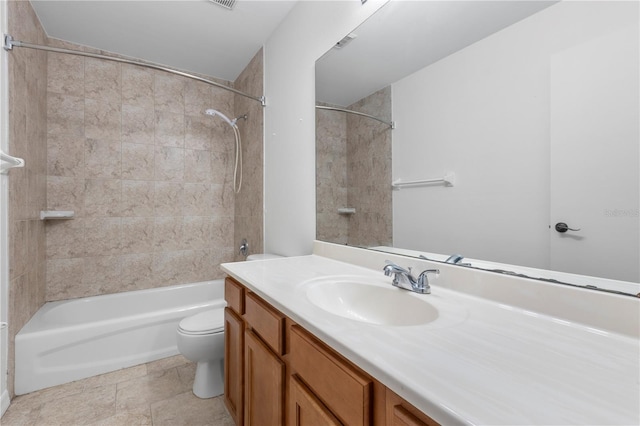 full bathroom with vanity, tiled shower / bath combo, and toilet