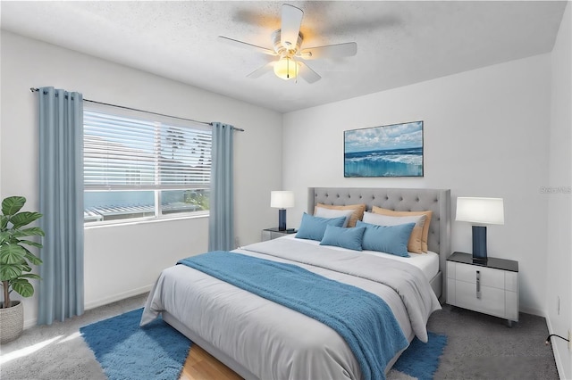 bedroom featuring carpet, a textured ceiling, and ceiling fan