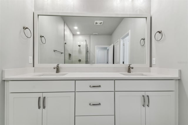 bathroom featuring vanity and an enclosed shower