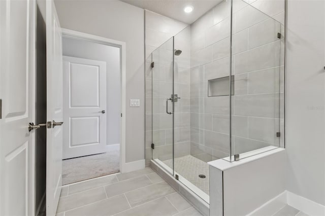 bathroom with tile patterned flooring and walk in shower