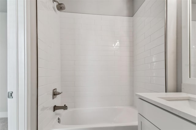 bathroom featuring vanity and tiled shower / bath