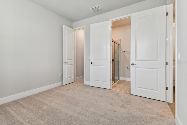 unfurnished bedroom featuring light carpet