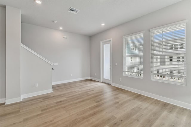 interior space with a textured ceiling and light hardwood / wood-style flooring