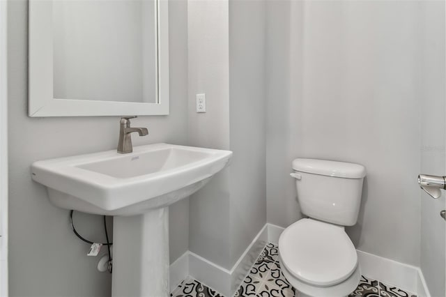 bathroom featuring tile patterned floors, sink, and toilet