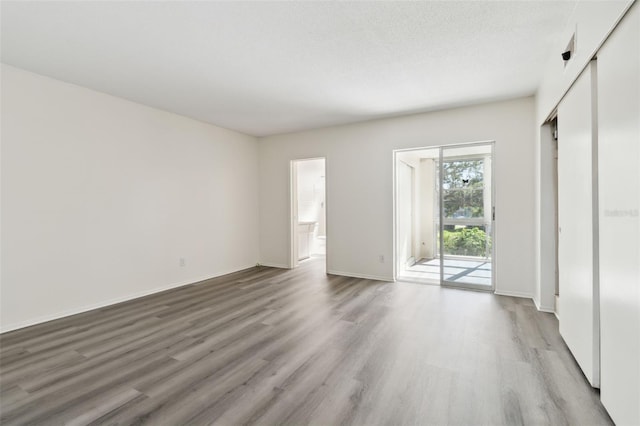 interior space with hardwood / wood-style floors and a textured ceiling