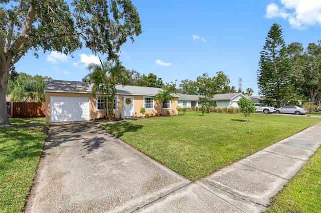 ranch-style house featuring a garage, fence, concrete driveway, stucco siding, and a front yard