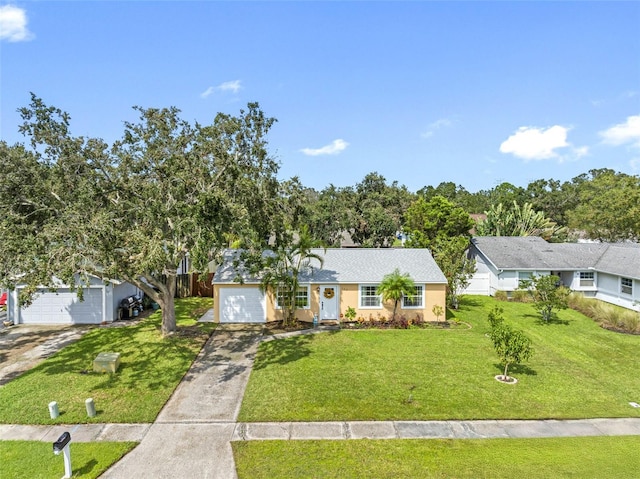 ranch-style house with driveway, a garage, and a front yard