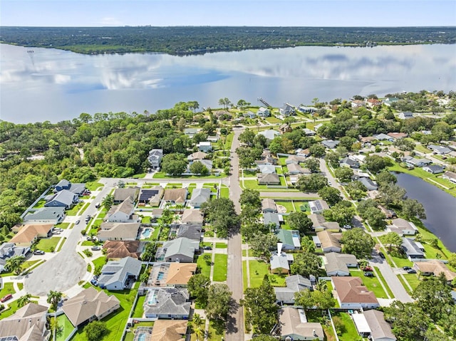 drone / aerial view featuring a water view and a residential view