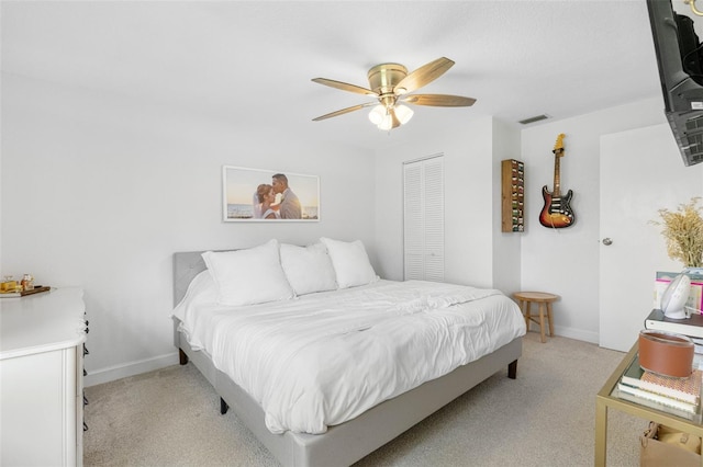 bedroom featuring light carpet, ceiling fan, visible vents, and baseboards