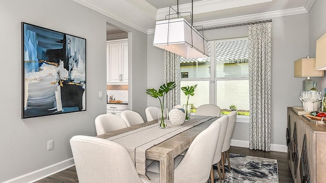 dining room with plenty of natural light, dark hardwood / wood-style flooring, and ornamental molding