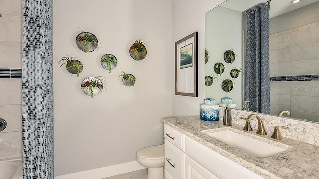 bathroom featuring tile patterned flooring, vanity, and toilet