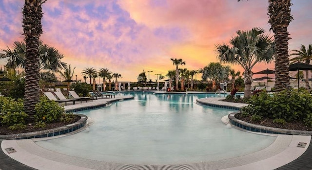 pool at dusk with a patio