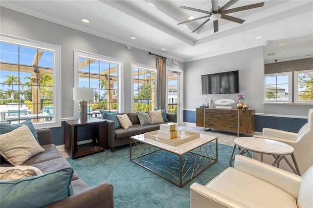 living room featuring ornamental molding and ceiling fan