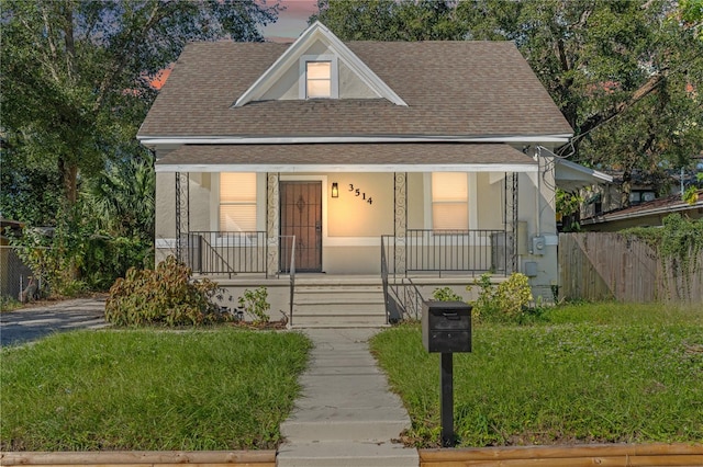 bungalow-style house featuring a yard and a porch