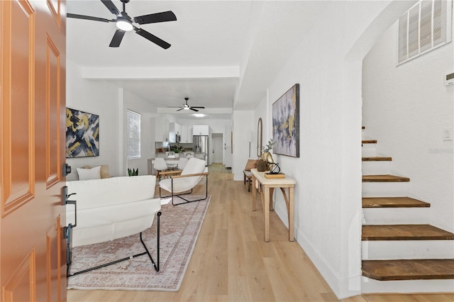 living room featuring light hardwood / wood-style floors and ceiling fan