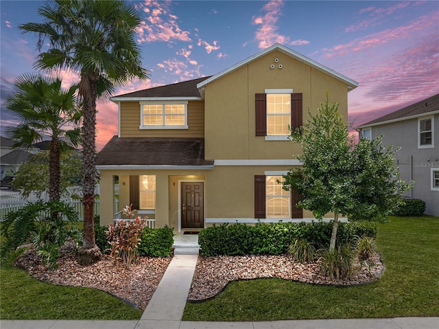 8720 Savory Walk Dr, Land O Lakes, FL 34637 - traditional-style house with covered porch, a shingled roof, a front yard, and stucco siding