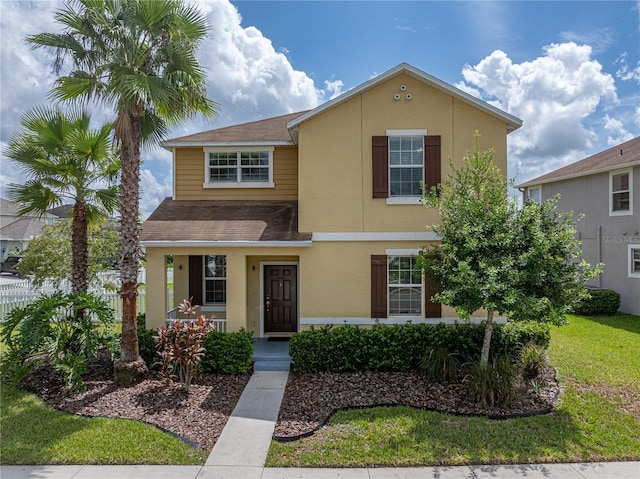 8720 Savory Walk Dr, Land O Lakes, FL 34637 - traditional-style house with covered porch, a shingled roof, a front yard, and stucco siding