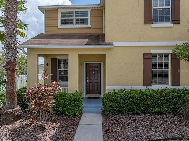 8720 Savory Walk Dr, Land O Lakes, FL 34637 - entrance to property featuring roof with shingles, stucco siding, and fence